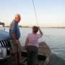 Manuela from Child's Dream and Dad on board the punt crossing Mekong