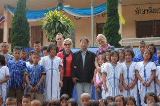 opening ceremony with the new school building in the background